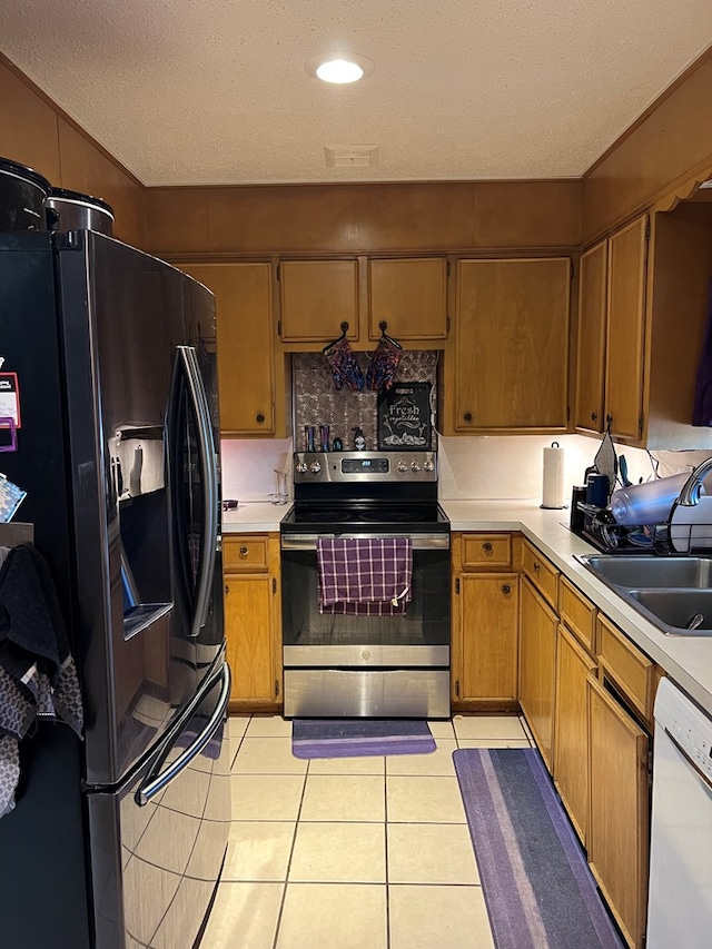 kitchen with stainless steel electric stove, white dishwasher, sink, a textured ceiling, and fridge with ice dispenser