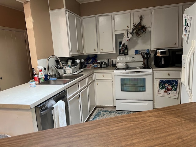 kitchen featuring kitchen peninsula, white appliances, and sink