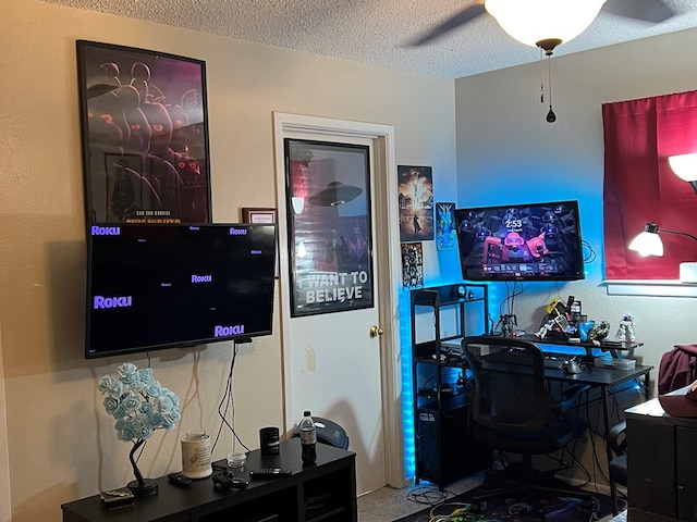 office space with ceiling fan and a textured ceiling