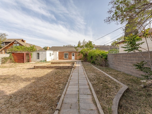 back of property featuring brick siding and fence private yard