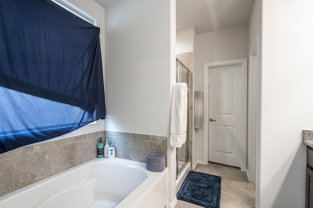 bathroom featuring vanity, a shower stall, a bath, and tile patterned flooring