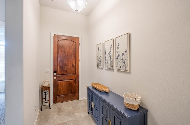 doorway featuring baseboards