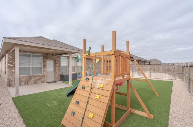 view of play area featuring a patio, a yard, and a fenced backyard