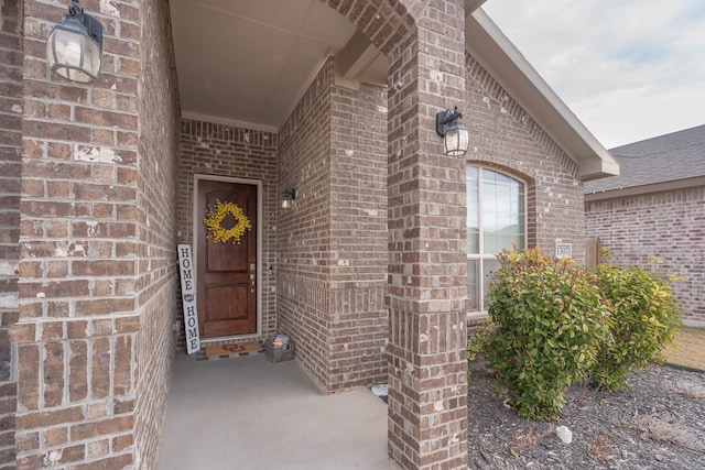 property entrance featuring brick siding