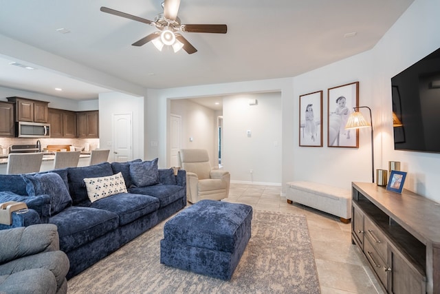 living room featuring light tile patterned flooring, recessed lighting, baseboards, and a ceiling fan