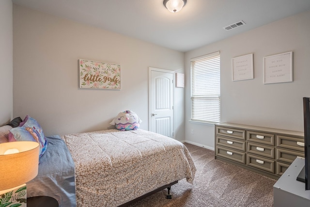 bedroom with baseboards, visible vents, and dark colored carpet