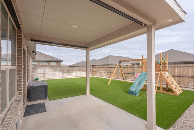 view of patio featuring a fenced backyard and a playground