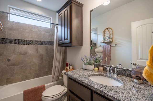 full bath with vanity, toilet, and shower / bath combo