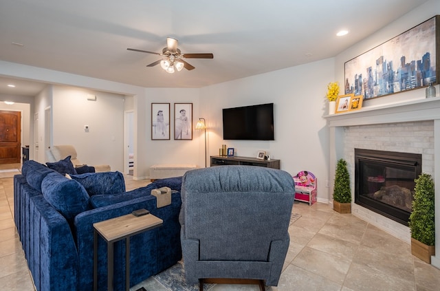 living area featuring recessed lighting, a fireplace, baseboards, and a ceiling fan