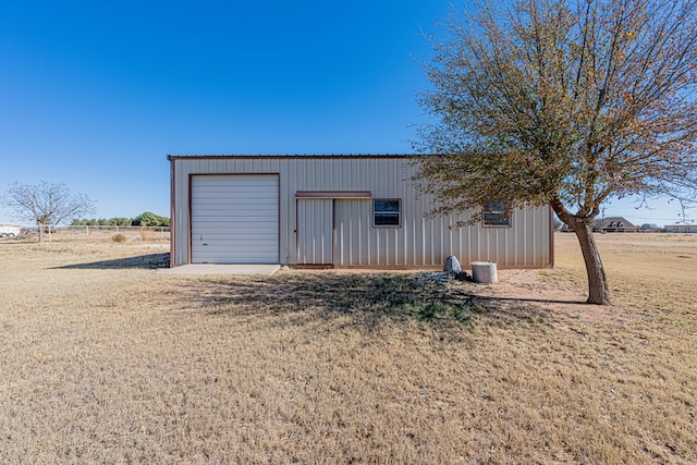 view of outbuilding with a garage and a lawn