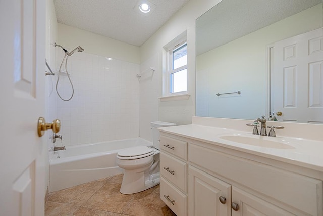 full bathroom with toilet, tiled shower / bath, a textured ceiling, vanity, and tile patterned flooring