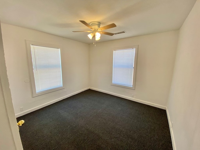 empty room featuring ceiling fan and carpet floors