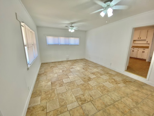 empty room with ceiling fan and crown molding