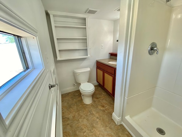 bathroom with walk in shower, vanity, and toilet