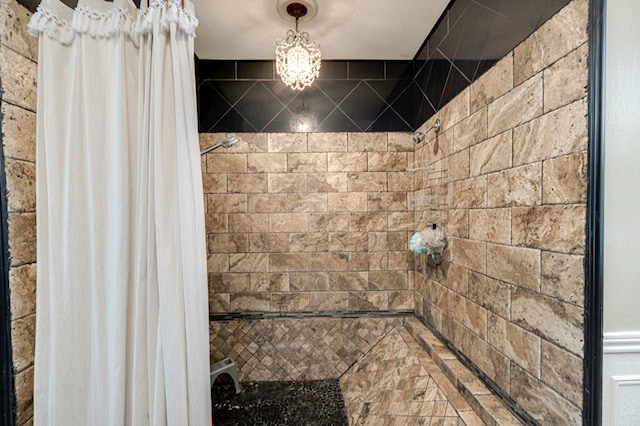 bathroom with tiled shower