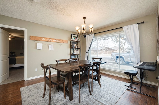 dining area featuring a notable chandelier, wood finished floors, and baseboards