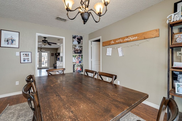 dining area featuring french doors, a textured ceiling, visible vents, and dark wood-style floors