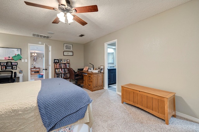 bedroom featuring visible vents, light carpet, a textured ceiling, and baseboards