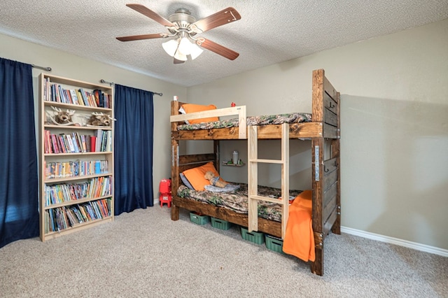 bedroom featuring baseboards, ceiling fan, a textured ceiling, and carpet