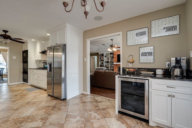 kitchen with white cabinetry, beverage cooler, stainless steel fridge, and ceiling fan