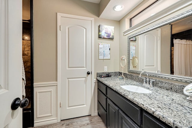 bathroom featuring wood finished floors and vanity