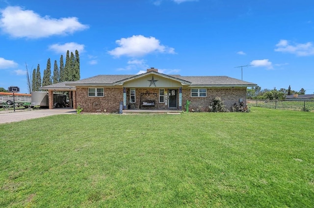 ranch-style house featuring a carport and a front lawn