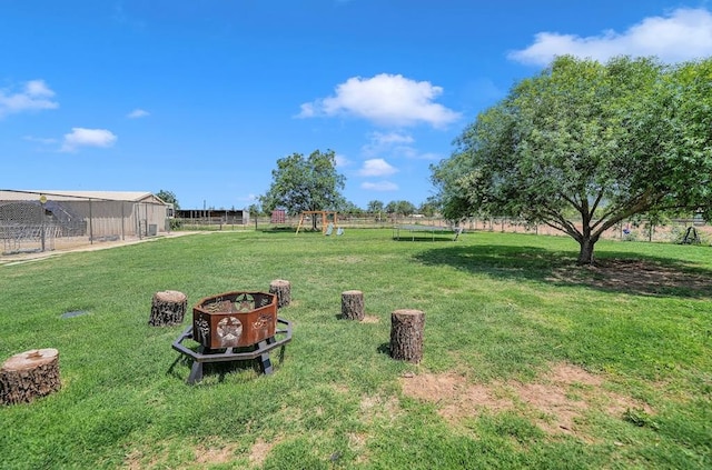 view of yard with a playground and a trampoline