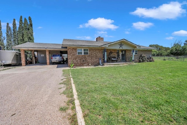 view of front of house with a front lawn and a carport