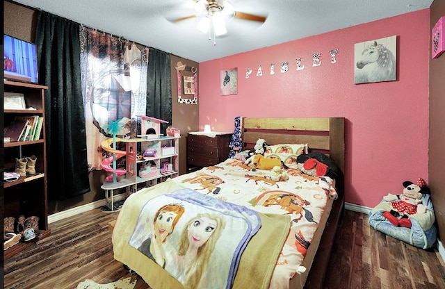 bedroom with ceiling fan and dark hardwood / wood-style floors