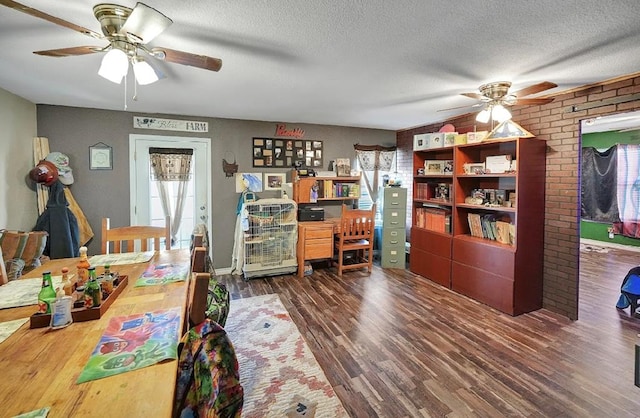 office area with a textured ceiling, dark hardwood / wood-style floors, and ceiling fan