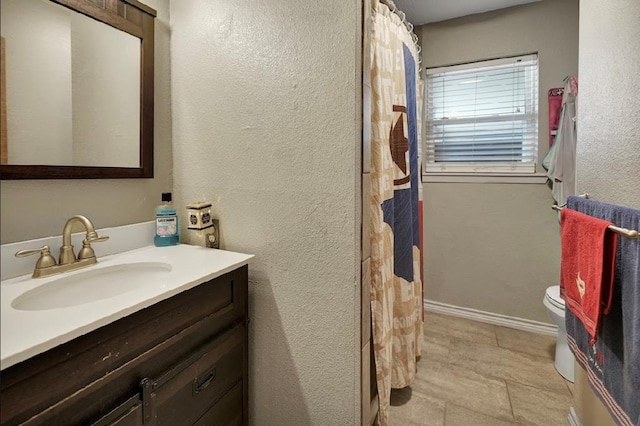 bathroom with vanity and toilet