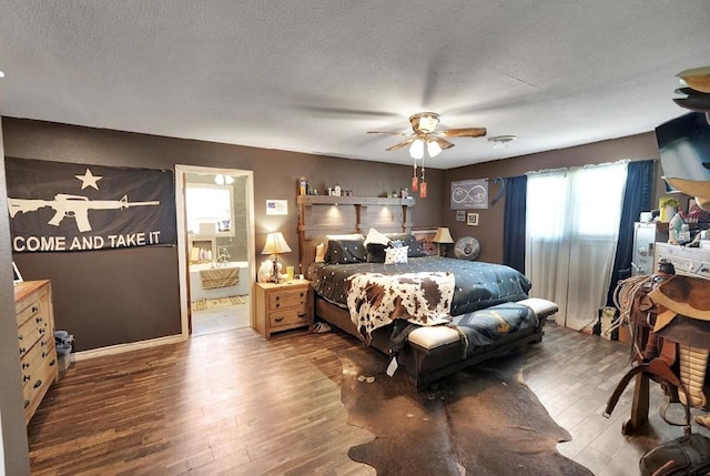 bedroom with hardwood / wood-style floors, a textured ceiling, ensuite bathroom, and ceiling fan