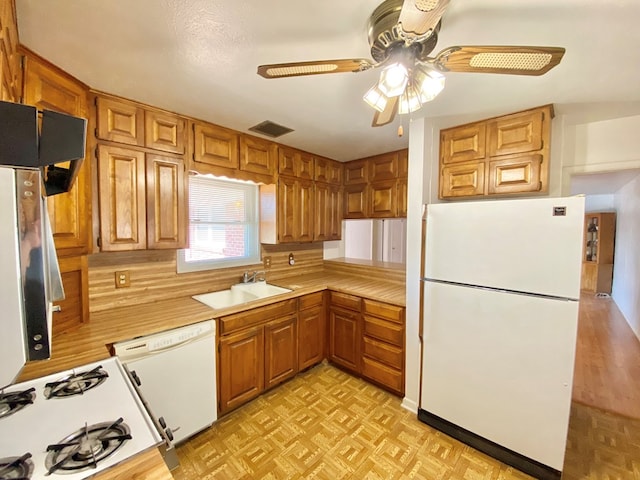 2107 Alabama St, Big Spring, TX 79720 - kitchen featuring white appliances, a sink, light countertops, a ceiling fan, and decorative backsplash