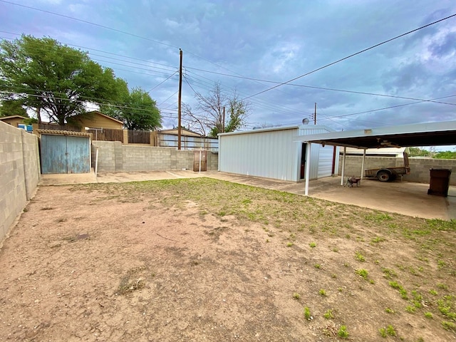 2107 Alabama St, Big Spring, TX 79720 - view of yard featuring fence, an outdoor structure, and a carport