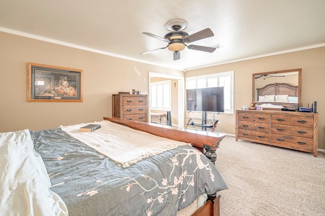 carpeted bedroom featuring ceiling fan and crown molding