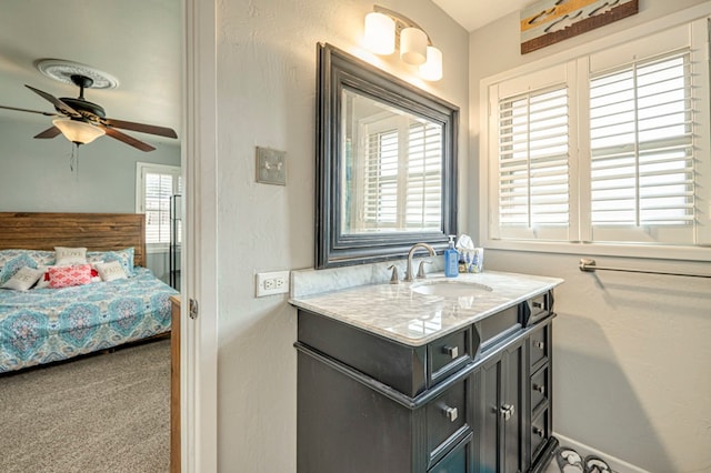 bathroom featuring vanity, ceiling fan, and a wealth of natural light