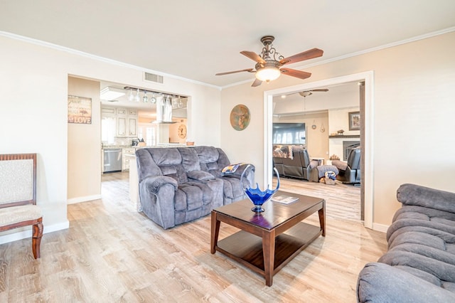 living room featuring ceiling fan, light hardwood / wood-style flooring, and ornamental molding