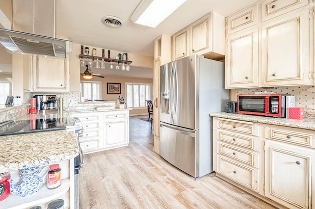 kitchen with ceiling fan, stainless steel fridge with ice dispenser, exhaust hood, and tasteful backsplash