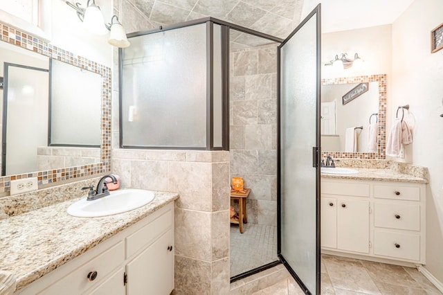 bathroom with backsplash, vanity, an enclosed shower, and tile walls