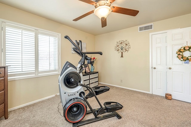 exercise room with ceiling fan and light colored carpet