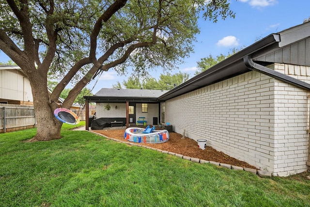 4901 Chon Cv, Midland, TX 79707 - rear view of property featuring a fenced backyard, brick siding, and a patio