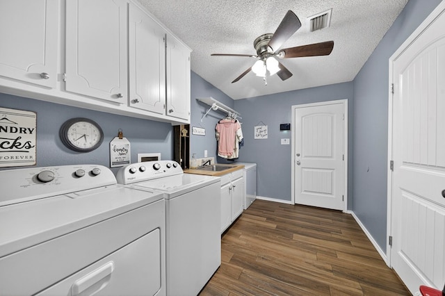 4901 Chon Cv, Midland, TX 79707 - washroom featuring separate washer and dryer, cabinet space, ceiling fan, a textured ceiling, and dark wood-style flooring