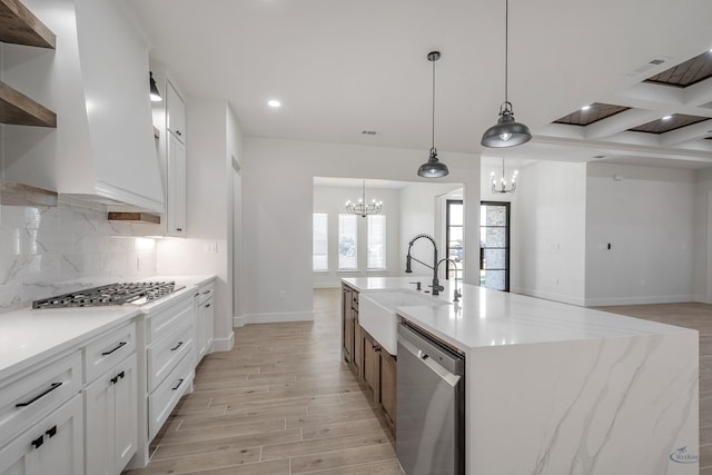 kitchen with light wood-type flooring, white cabinetry, sink, and appliances with stainless steel finishes