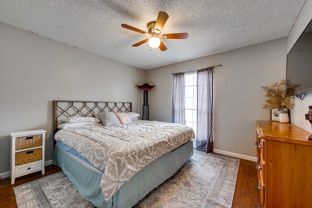 3906 Lehigh Dr, Midland, TX 79707 - bedroom featuring a textured ceiling, wood finished floors, baseboards, and ceiling fan