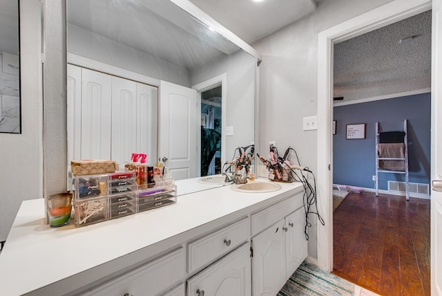 3906 Lehigh Dr, Midland, TX 79707 - bathroom featuring vanity, wood finished floors, and a textured ceiling