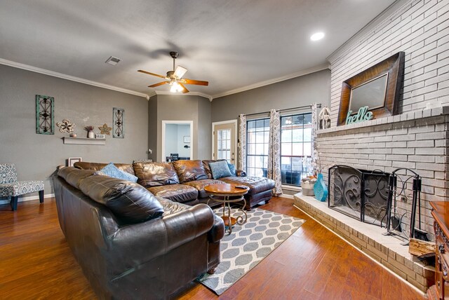 3906 Lehigh Dr, Midland, TX 79707 - living room featuring a ceiling fan, wood finished floors, crown molding, a brick fireplace, and baseboards