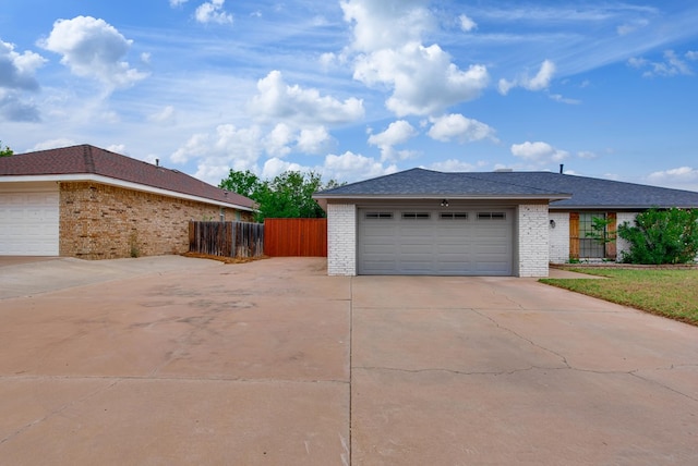 3906 Lehigh Dr, Midland, TX 79707 - view of side of property with driveway, brick siding, and an attached garage