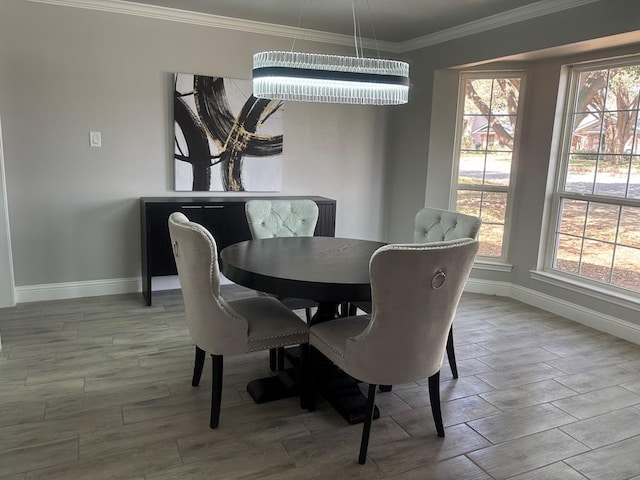 dining space with crown molding, baseboards, and wood finish floors