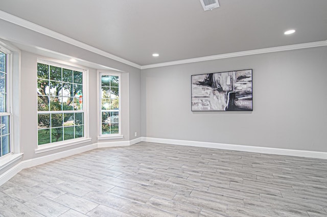 unfurnished room with visible vents, wood finished floors, recessed lighting, crown molding, and baseboards