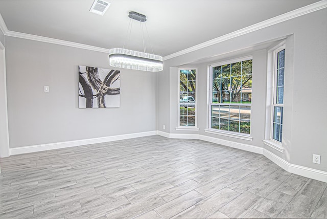 unfurnished dining area featuring an inviting chandelier, ornamental molding, and light wood-type flooring